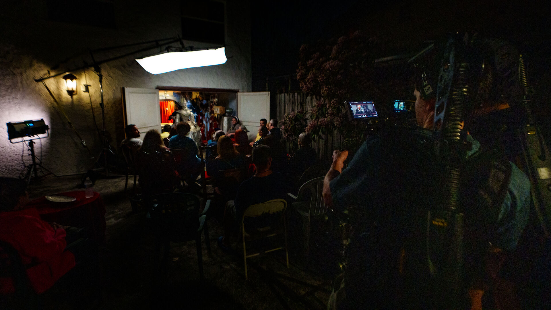 Artist surrounded by vibrant paintings in studio