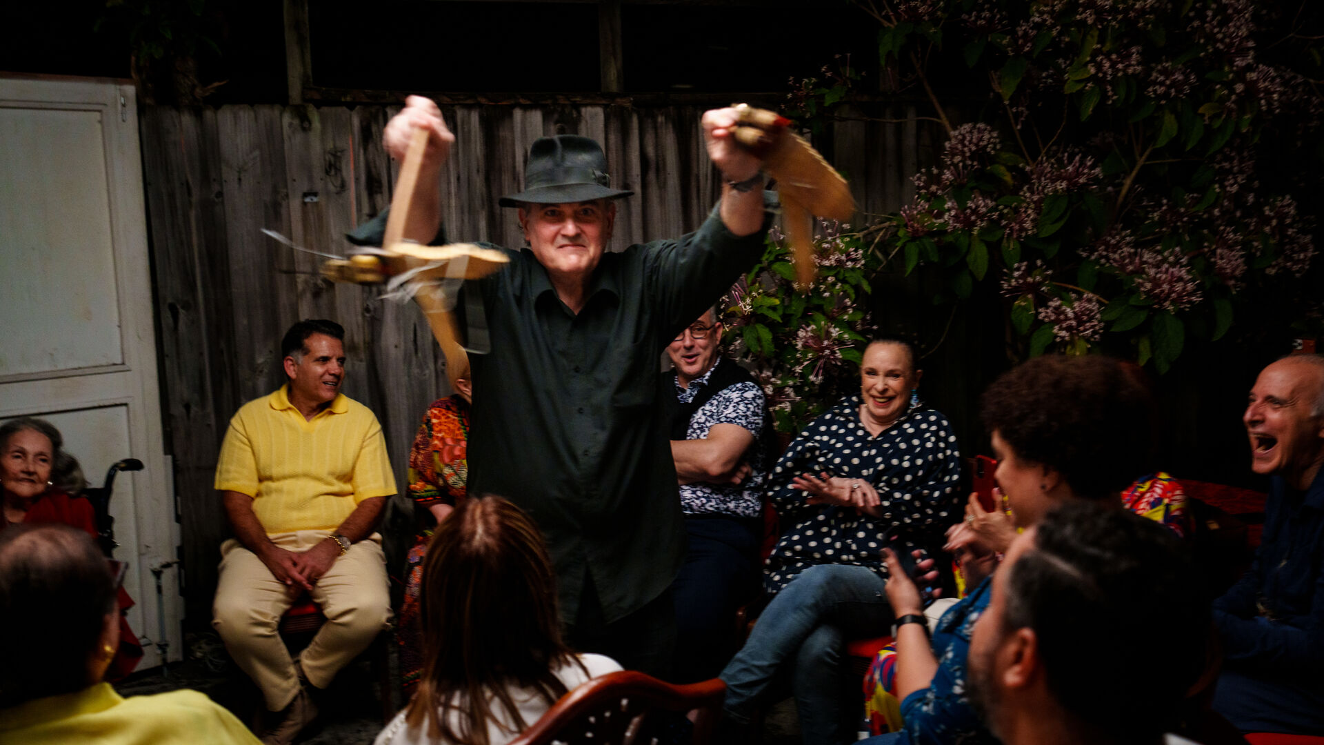 Performer with crowd laughing during community gathering
